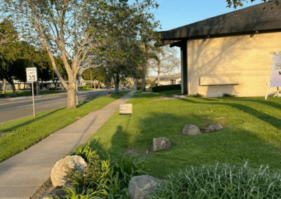 Area with building and sidewalk landscaped.